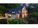 Lovely two-story home featuring a brick facade, attached garage, and mature landscaping at 3102 Royal Troon, Woodstock, GA 30189