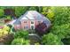Elegant brick home with manicured gardens and a inviting front entrance surrounded by lush greenery at 3102 Royal Troon, Woodstock, GA 30189