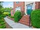 Charming brick home entrance featuring a well-manicured garden and landscaped walkway at 3102 Royal Troon, Woodstock, GA 30189