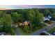 Aerial view of well-landscaped home exterior with mature trees and lush greenery at 3102 Royal Troon, Woodstock, GA 30189