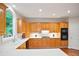 Well-lit kitchen featuring modern appliances and lots of wooden cabinets at 3102 Royal Troon, Woodstock, GA 30189