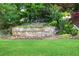 Landscaped yard with a flower bed and retaining wall at 3102 Royal Troon, Woodstock, GA 30189