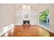 Cozy living room featuring a fireplace with built-in shelving and large windows at 3102 Royal Troon, Woodstock, GA 30189