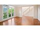 Bright and airy living room with gleaming hardwood floors and staircase at 3102 Royal Troon, Woodstock, GA 30189