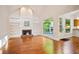 Living room with fireplace, built-ins, hardwood floors and access to the outdoor space at 3102 Royal Troon, Woodstock, GA 30189