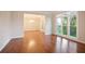 Bright living room with hardwood floors and a large window showing lush greenery at 3102 Royal Troon, Woodstock, GA 30189