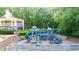 Community playground featuring slides, climbing structures, and wood-chip ground cover at 3102 Royal Troon, Woodstock, GA 30189