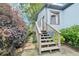 Charming back entrance with wooden steps surrounded by lush greenery offers privacy and curb appeal at 621 Mcgruder Ne St, Atlanta, GA 30312