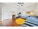 Bedroom with hardwood floors, decorative fireplace, two twin beds with yellow rug and ceiling fan at 621 Mcgruder Ne St, Atlanta, GA 30312