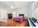 Bedroom featuring hardwood floors, electric piano and white ceiling fan at 621 Mcgruder Ne St, Atlanta, GA 30312