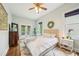 Bedroom with white bedding, rug, doors to deck, stylish decor and ceiling fan at 621 Mcgruder Ne St, Atlanta, GA 30312