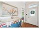 Classic entryway featuring hardwood floors, decorative chest, mirror, and a view into another room at 621 Mcgruder Ne St, Atlanta, GA 30312