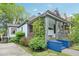 Charming two-story home featuring a covered porch, lush greenery, and blue painted stairs at 621 Mcgruder Ne St, Atlanta, GA 30312