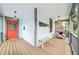 Inviting front porch featuring a cozy seating area, an orange front door, and nautical accents at 621 Mcgruder Ne St, Atlanta, GA 30312