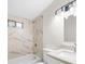 Bright bathroom featuring tub/shower combination with white tile and modern lighting at 146 Mount Paran Ne Rd, Atlanta, GA 30342