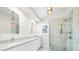 Bright bathroom featuring double sinks, sleek countertops, and a marble-tiled shower at 146 Mount Paran Ne Rd, Atlanta, GA 30342