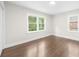 Bedroom with hardwood floors, white walls, and two windows allowing natural light and view of outside at 146 Mount Paran Ne Rd, Atlanta, GA 30342