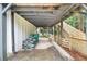 View of a covered carport with stacked supplies and backyard access at 146 Mount Paran Ne Rd, Atlanta, GA 30342