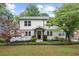 Charming two-story home with white siding, black trim, and well-manicured landscaping at 146 Mount Paran Ne Rd, Atlanta, GA 30342