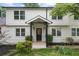 Inviting front porch with black door, contrasting trim, and manicured bushes at 146 Mount Paran Ne Rd, Atlanta, GA 30342