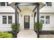 Covered porch with black support columns, transom window, and manicured landscaping at 146 Mount Paran Ne Rd, Atlanta, GA 30342