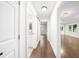 Hallway features hardwood floors, white walls, and doors to bathrooms, bedrooms, and living spaces at 146 Mount Paran Ne Rd, Atlanta, GA 30342