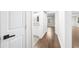 Bright hallway featuring hardwood floors, white walls, and doors to bathrooms and bedrooms at 146 Mount Paran Ne Rd, Atlanta, GA 30342