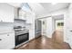 Modern kitchen featuring white cabinets, stainless steel appliances, and a sliding door at 146 Mount Paran Ne Rd, Atlanta, GA 30342