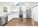 Bright kitchen with white cabinets, stainless steel appliances, and vaulted ceilings at 146 Mount Paran Ne Rd, Atlanta, GA 30342
