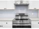 Close up of a stainless steel range and white backsplash at 146 Mount Paran Ne Rd, Atlanta, GA 30342