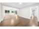 Open-concept living area with hardwood floors and access to a bright sunroom at 146 Mount Paran Ne Rd, Atlanta, GA 30342