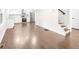 Bright living area featuring hardwood floors, white walls, and an open staircase at 146 Mount Paran Ne Rd, Atlanta, GA 30342