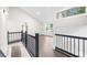 Upstairs hallway featuring black railings, hardwood floors, and plenty of natural light at 146 Mount Paran Ne Rd, Atlanta, GA 30342