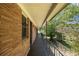 This covered porch has a black railing and brick wall at 201 E Simon Nw Ter, Atlanta, GA 30318
