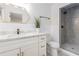 A sleek bathroom showcases updated fixtures, marble countertop, modern shower and a hexagonal mirror at 201 E Simon Nw Ter, Atlanta, GA 30318