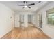 This bedroom boasts mirrored closets, hardwood floors, white walls, windows, and a ceiling fan at 201 E Simon Nw Ter, Atlanta, GA 30318