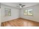 Bright bedroom featuring hardwood floors, a ceiling fan, and natural light from two windows at 201 E Simon Nw Ter, Atlanta, GA 30318
