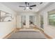 Bedroom features hardwood floors, an overhead fan, and access to an outdoor patio at 201 E Simon Nw Ter, Atlanta, GA 30318