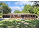 Charming brick home with an attached garage, well-manicured lawn, and mature trees at 201 E Simon Nw Ter, Atlanta, GA 30318