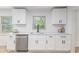 Bright, updated kitchen features white cabinets, stainless steel appliances, and stylish countertops at 201 E Simon Nw Ter, Atlanta, GA 30318