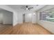 Bright living room boasts gleaming wood floors, ceiling fan, and large window at 201 E Simon Nw Ter, Atlanta, GA 30318