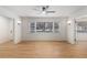 Bright living room features hardwood floors, modern ceiling fan, and ample natural light from a large window at 201 E Simon Nw Ter, Atlanta, GA 30318