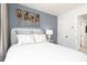 Inviting bedroom featuring serene blue wall and a plush queen bed with art deco headboard at 357 Skylar Se Ct, Atlanta, GA 30315