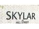 The 'Skylar at Hill Street' sign on the community's brick wall, showing location details at 357 Skylar Se Ct, Atlanta, GA 30315