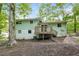 Green home featuring a backyard with a deck at 8857 Ashwood Dr, Riverdale, GA 30274
