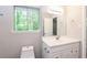 Bright bathroom with vanity and leafy view from window at 8857 Ashwood Dr, Riverdale, GA 30274