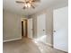 Neutral bedroom featuring a ceiling fan and closet at 8857 Ashwood Dr, Riverdale, GA 30274