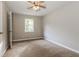 Neutral bedroom with wall-to-wall carpet and a single window for natural light at 8857 Ashwood Dr, Riverdale, GA 30274