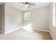 Sun-filled bedroom with neutral walls and plush carpet at 8857 Ashwood Dr, Riverdale, GA 30274