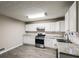 Updated kitchen featuring white cabinets, stone countertops, and stainless steel appliances at 8857 Ashwood Dr, Riverdale, GA 30274